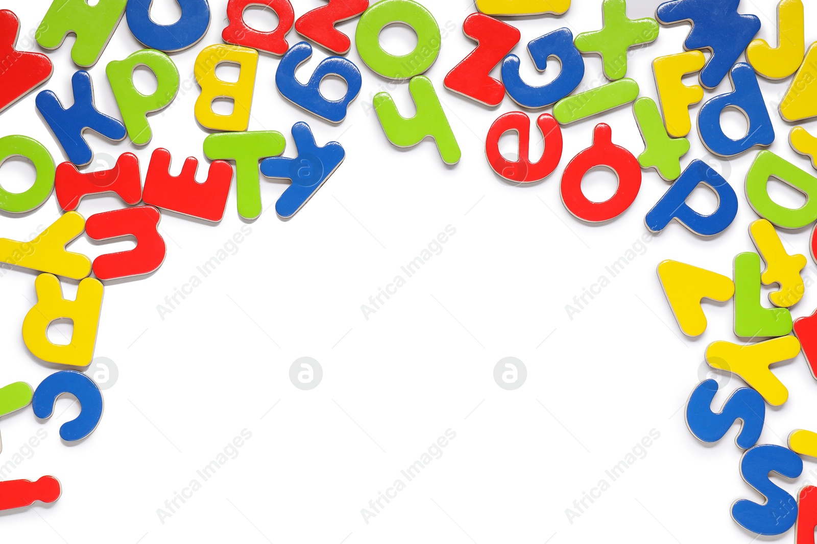 Photo of Alphabet. Many colorful magnetic letters isolated on white, top view