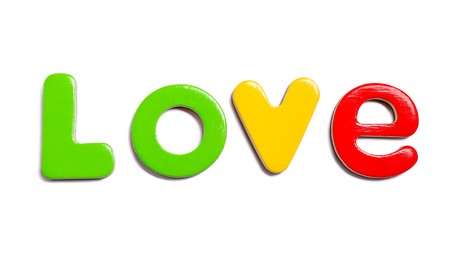 Photo of Alphabet. Word Love of magnetic letters isolated on white, top view