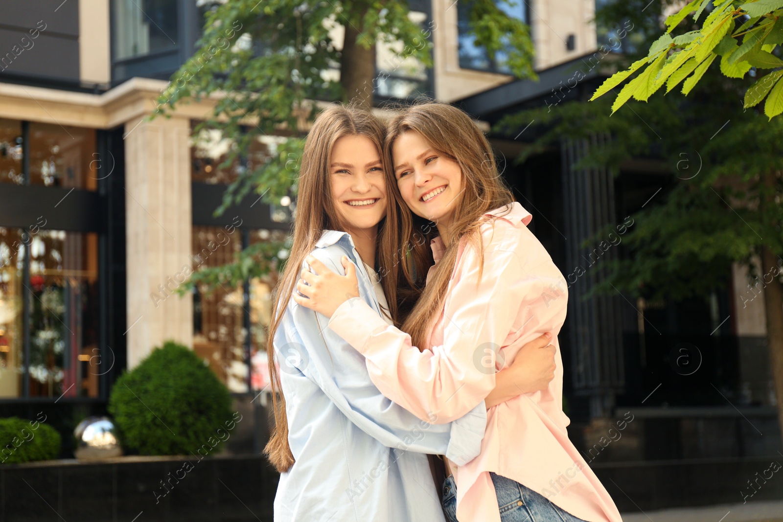 Photo of Two beautiful twin sisters spending time together outdoors