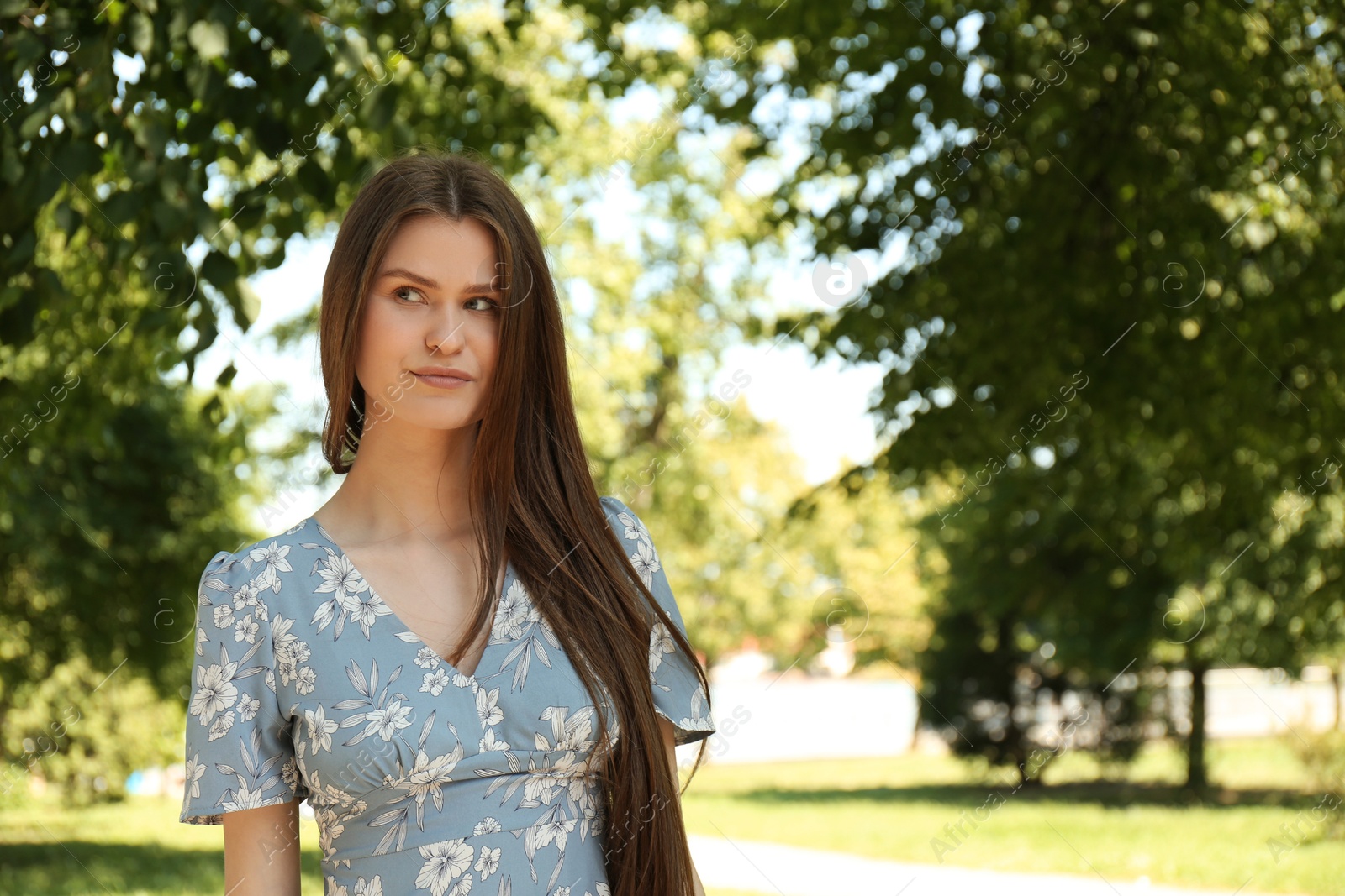 Photo of Portrait of beautiful woman in summer park, space for text