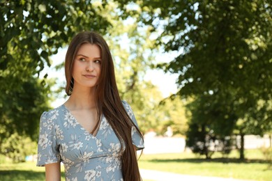 Photo of Portrait of beautiful woman in summer park, space for text