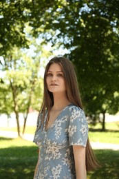 Portrait of beautiful woman in summer park