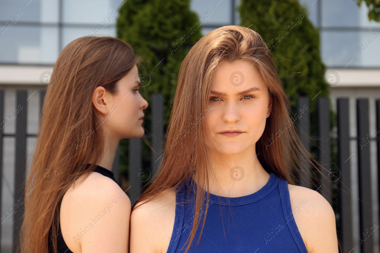 Photo of Two beautiful twin sisters outdoors, selective focus