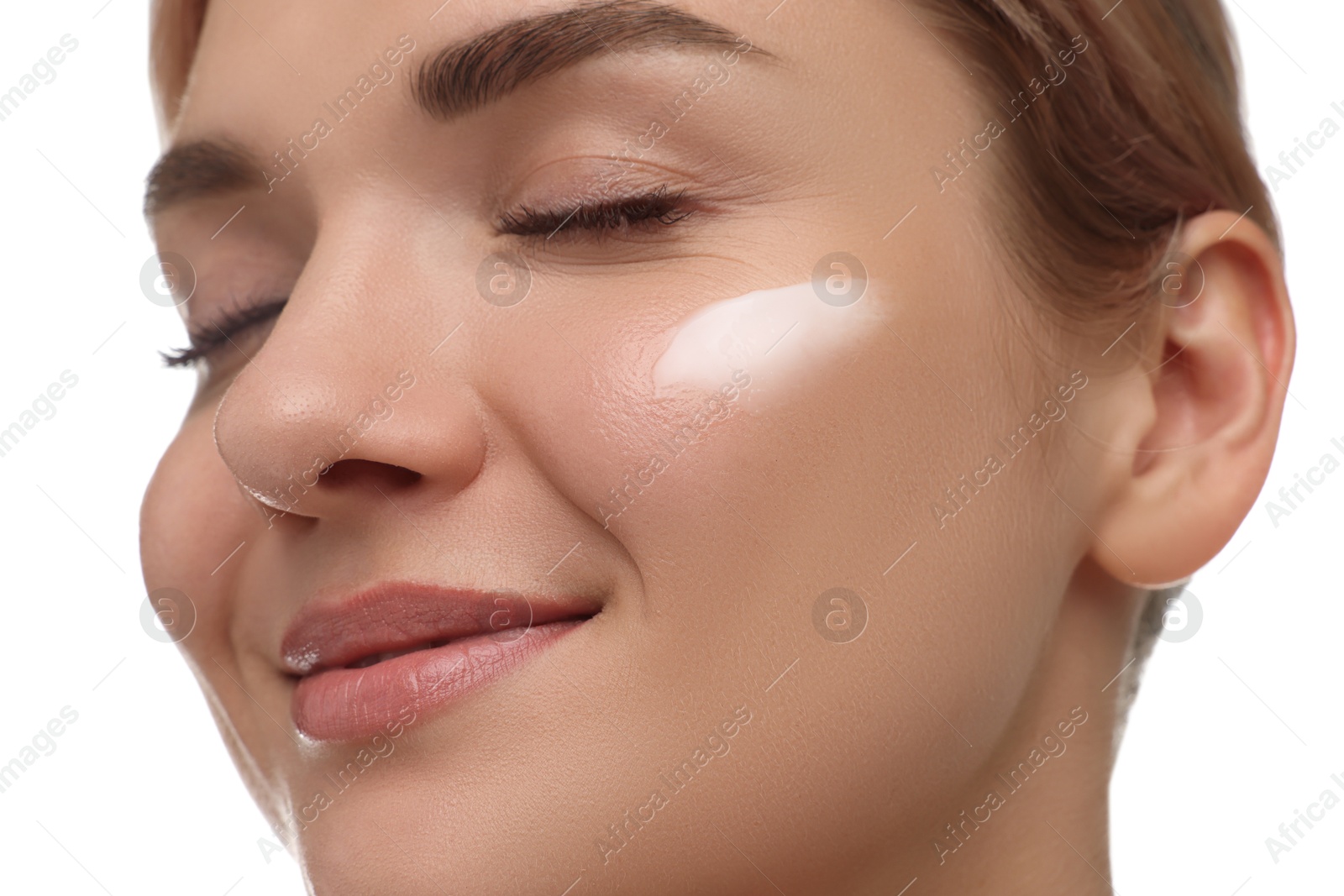 Photo of Beautiful woman with cream on her face against white background, closeup