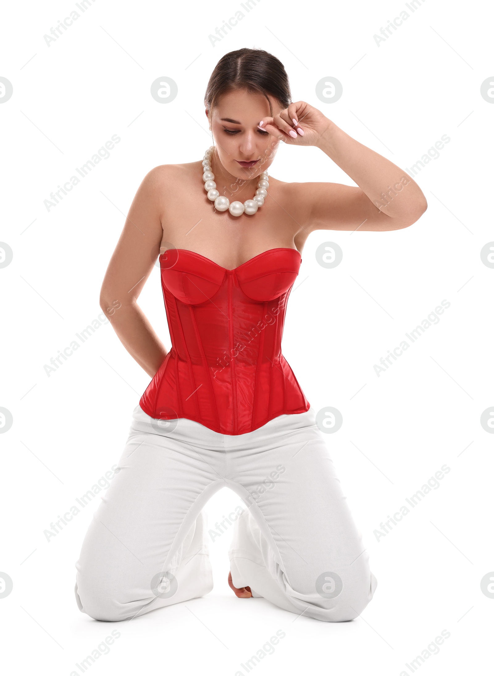 Photo of Beautiful woman in red corset posing on white background