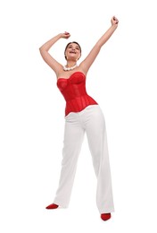 Smiling woman in red corset posing on white background, low angle view