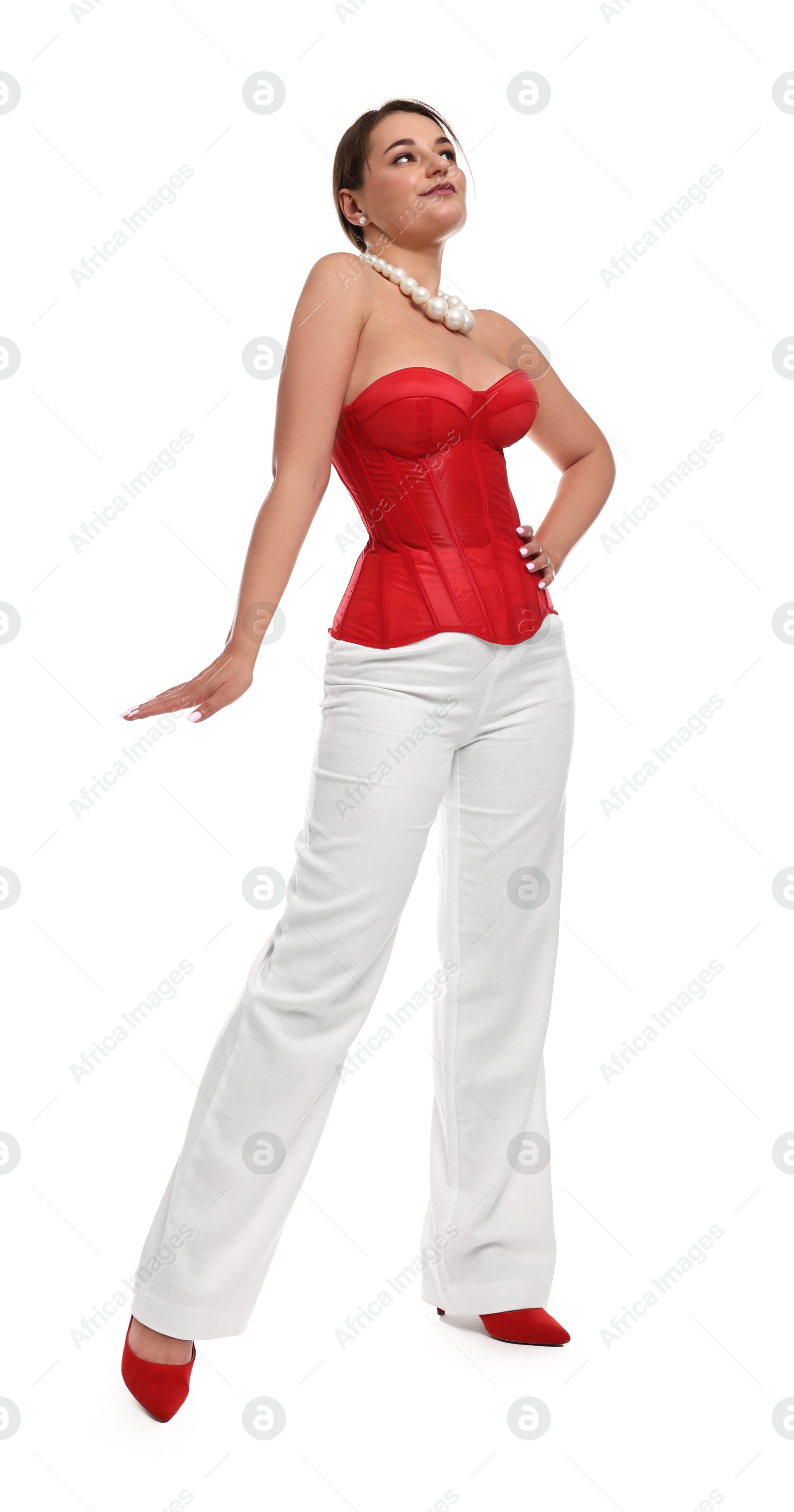 Photo of Beautiful woman in red corset posing on white background, low angle view