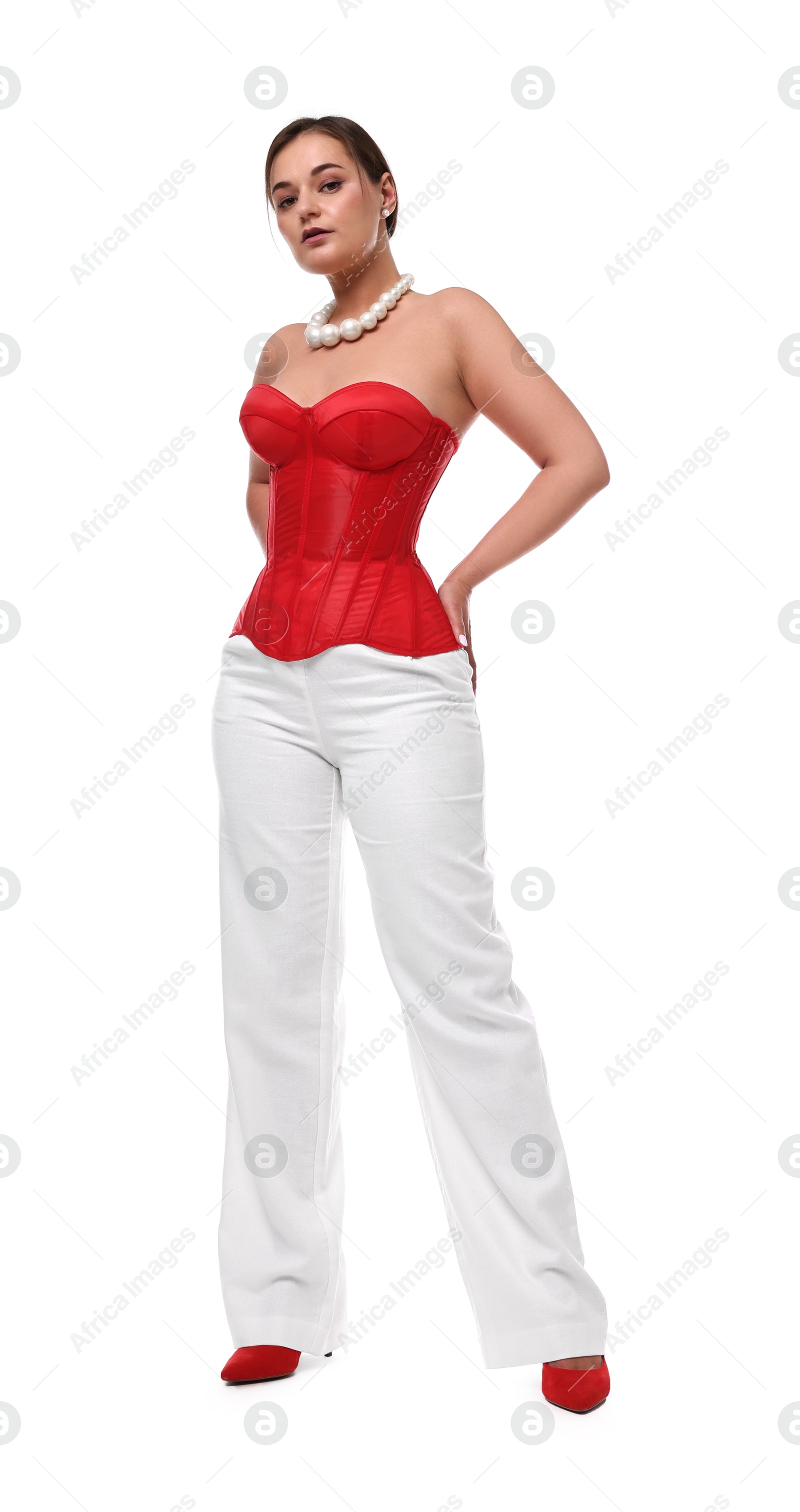 Photo of Beautiful woman in red corset posing on white background, low angle view