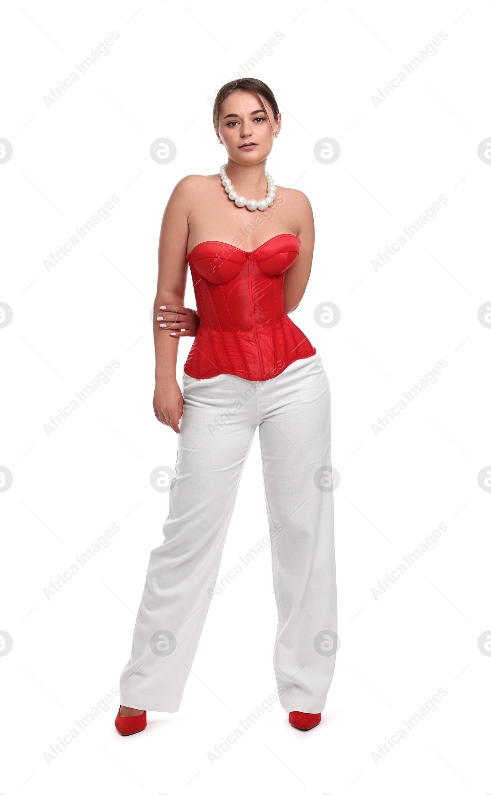 Photo of Beautiful woman in red corset posing on white background