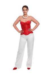 Beautiful woman in red corset posing on white background