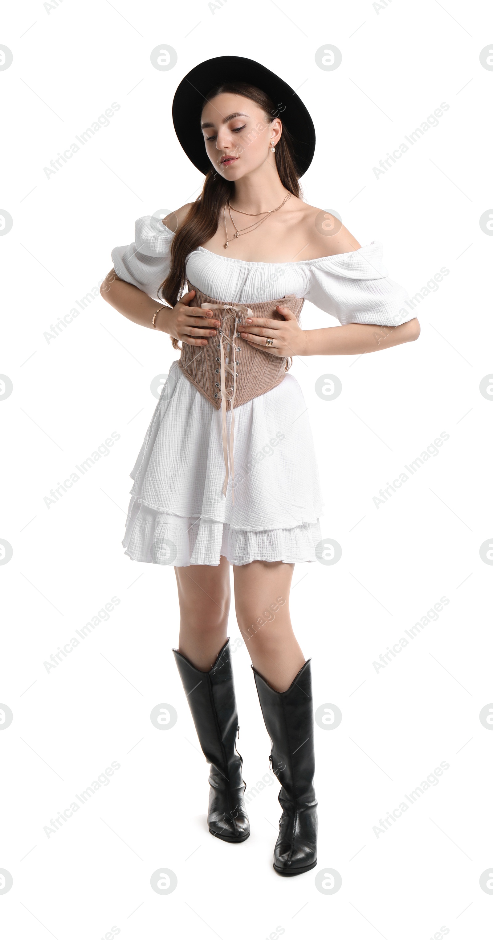 Photo of Beautiful woman in velvet corset and hat posing on white background