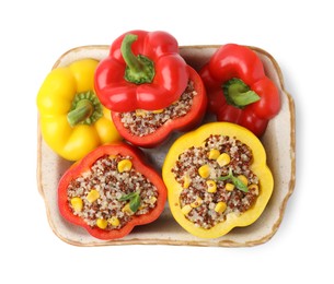 Photo of Quinoa stuffed bell peppers and basil in baking dish isolated on white, top view