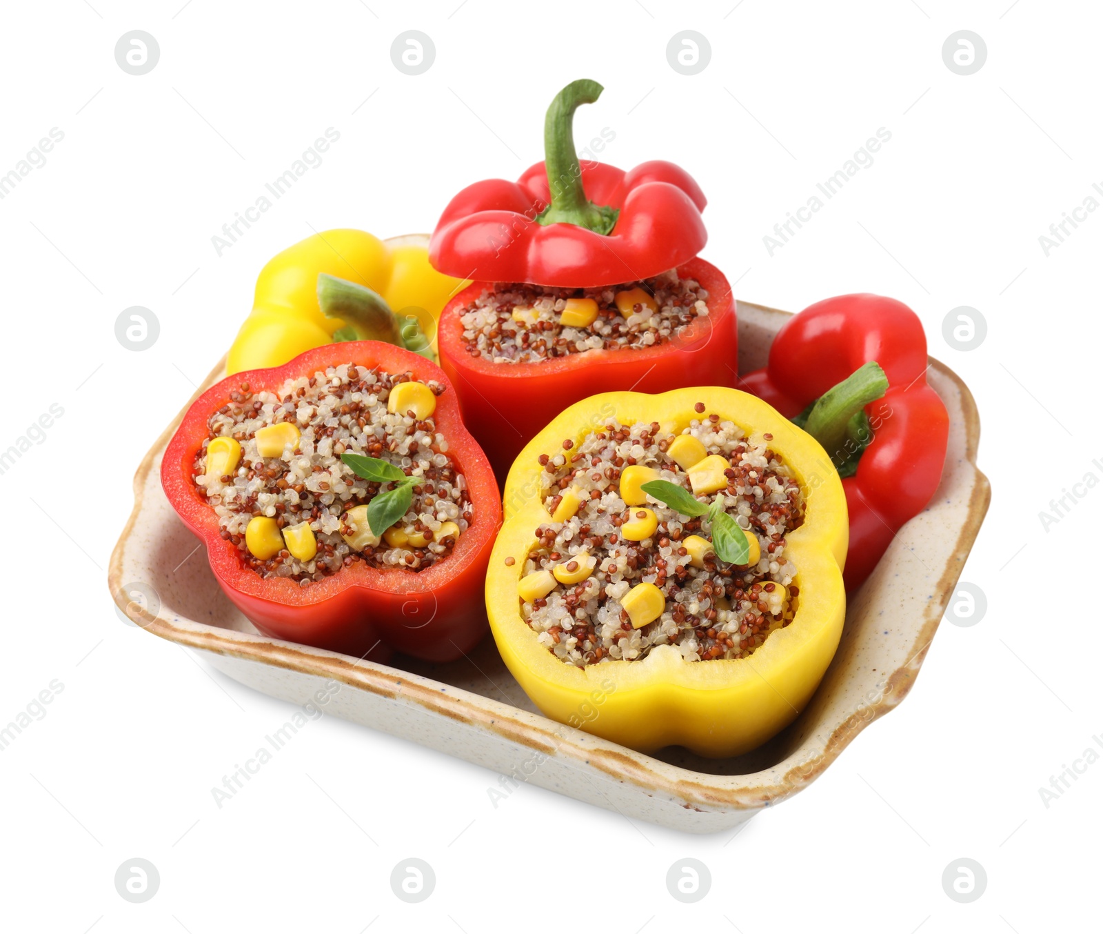 Photo of Quinoa stuffed bell peppers and basil in baking dish isolated on white