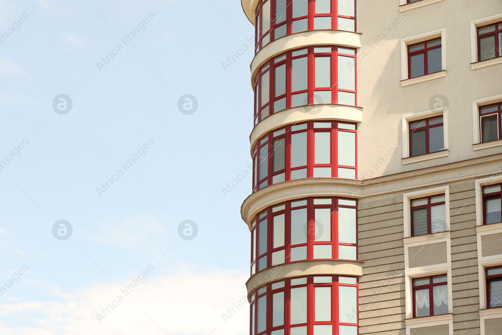 Photo of Modern building with glass windows outdoors, low angle view. Space for text