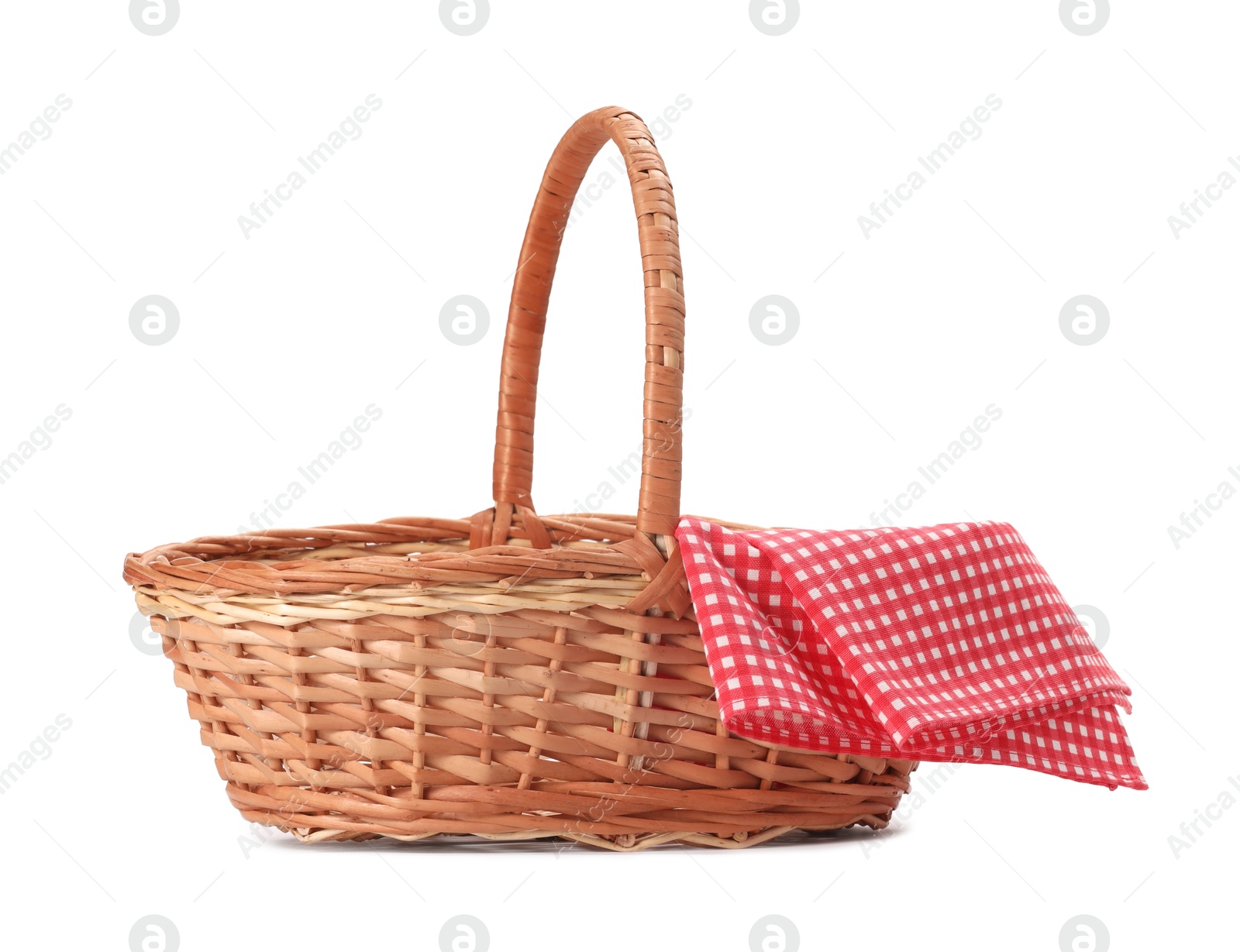 Photo of One picnic wicker basket with checkered napkin isolated on white