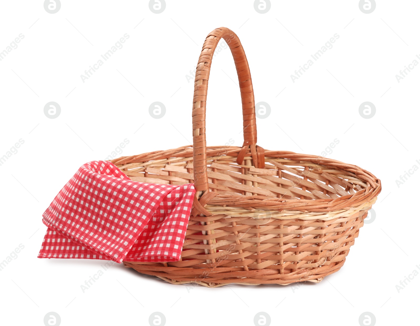 Photo of One picnic wicker basket with checkered napkin isolated on white