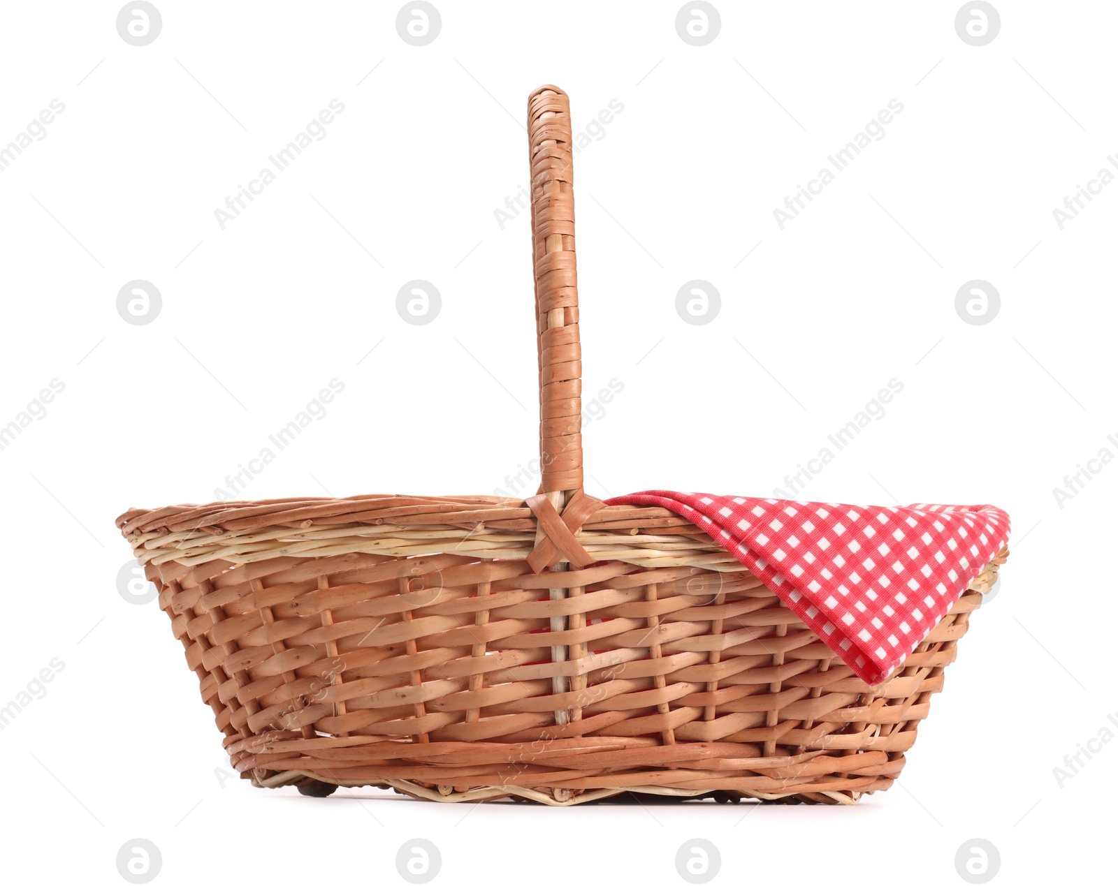 Photo of One picnic wicker basket with checkered napkin isolated on white