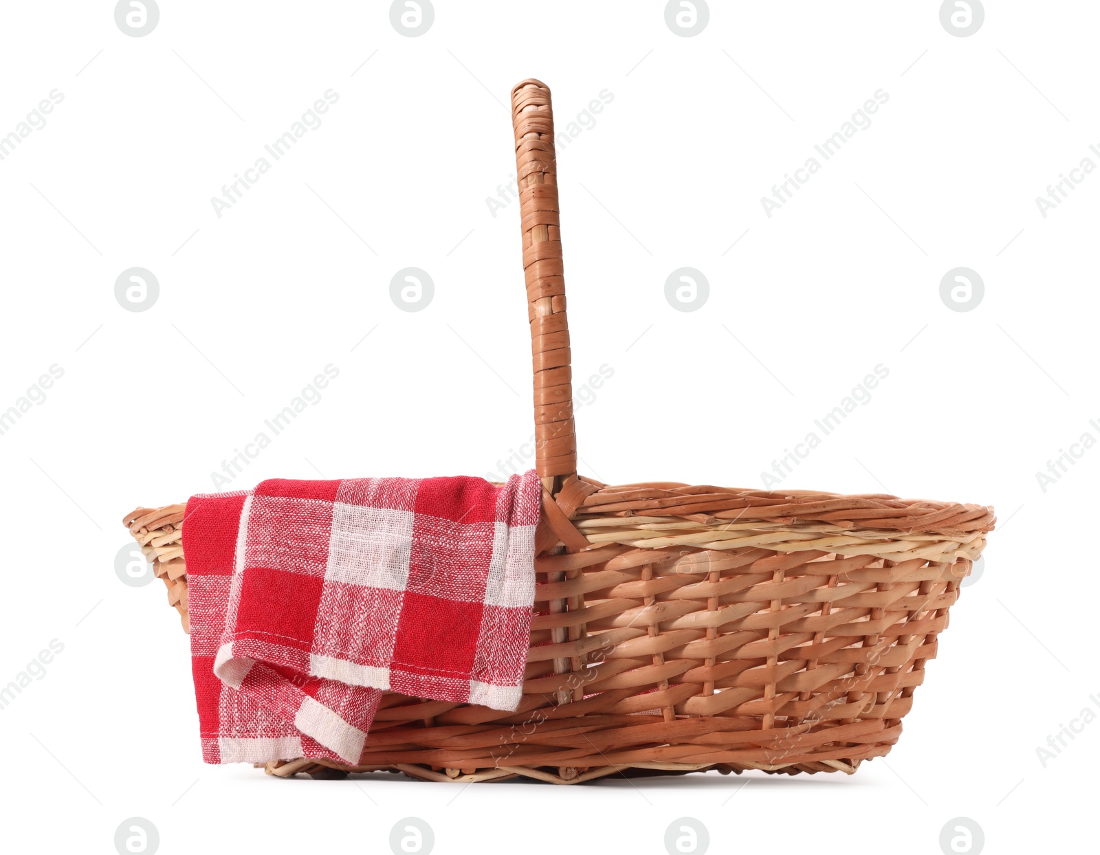 Photo of One picnic wicker basket with checkered napkin isolated on white