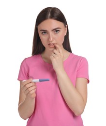 Confused woman holding pregnancy test on white background