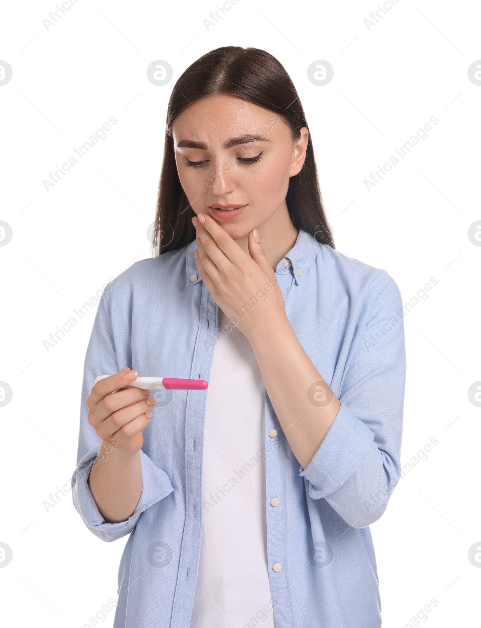 Photo of Sad woman holding pregnancy test on white background