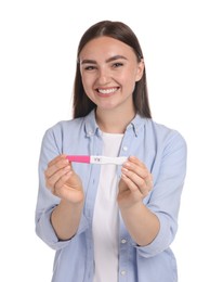 Happy woman holding pregnancy test on white background