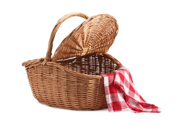 Photo of One open picnic wicker basket with checkered napkin isolated on white