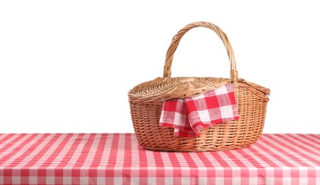 Photo of One picnic basket with napkin on table against white background. Space for text