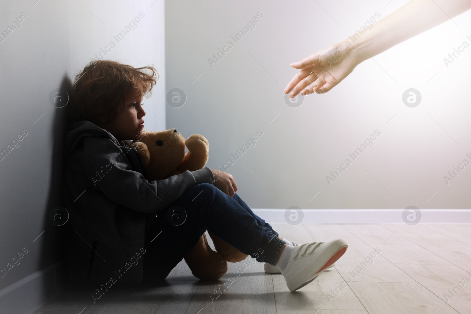 Image of Woman offering hand to sad child indoors. Trust, support, help