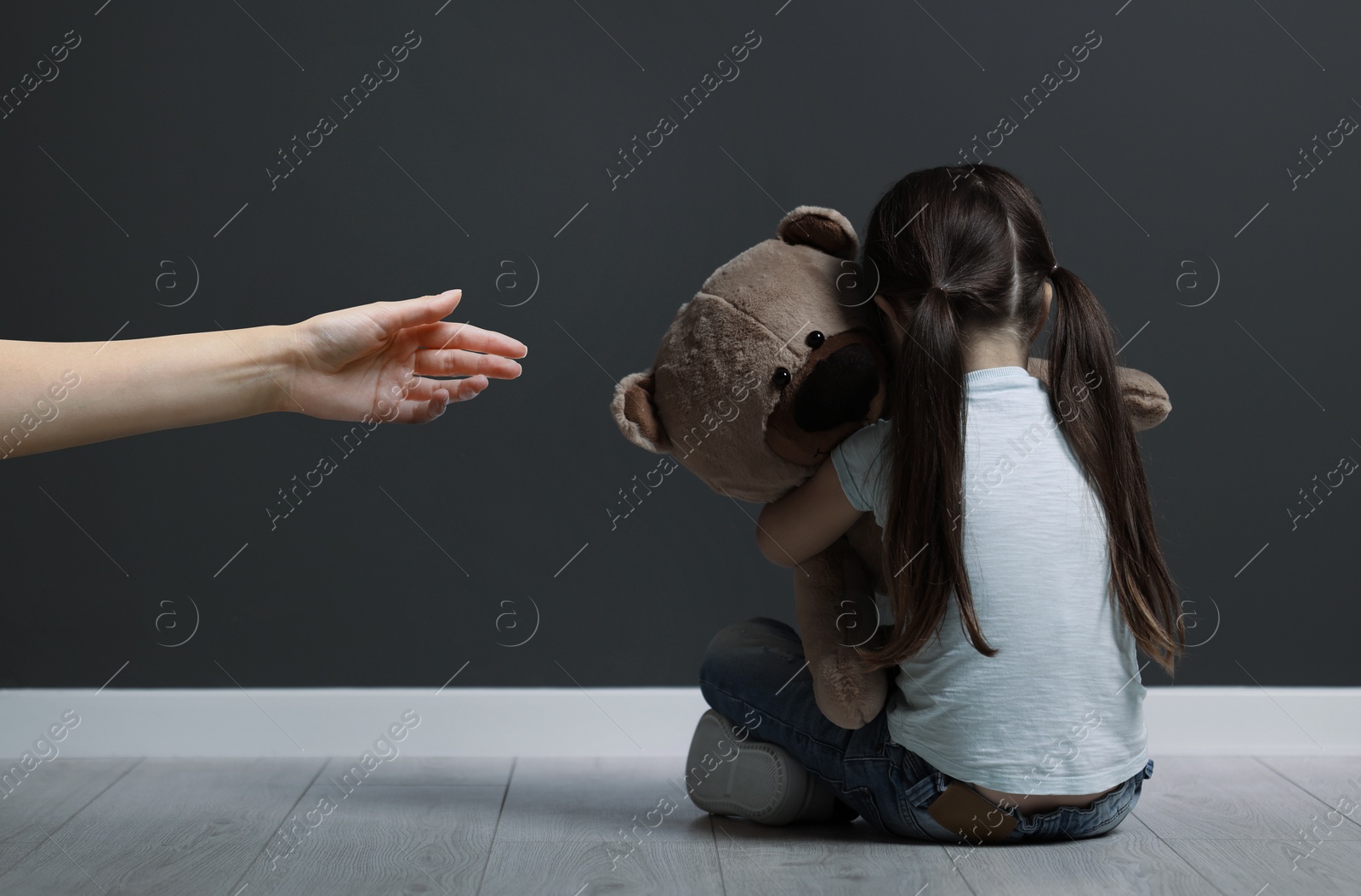 Image of Woman offering hand to sad child indoors. Trust, support, help