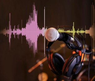 Image of Microphone, headphones and audio waveform in record studio