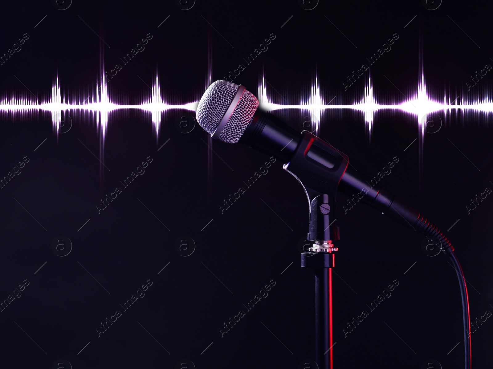 Image of Microphone and audio waveform on dark background