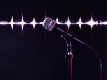 Image of Microphone and audio waveform on dark background