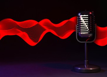 Image of Microphone and red sound waves on black background