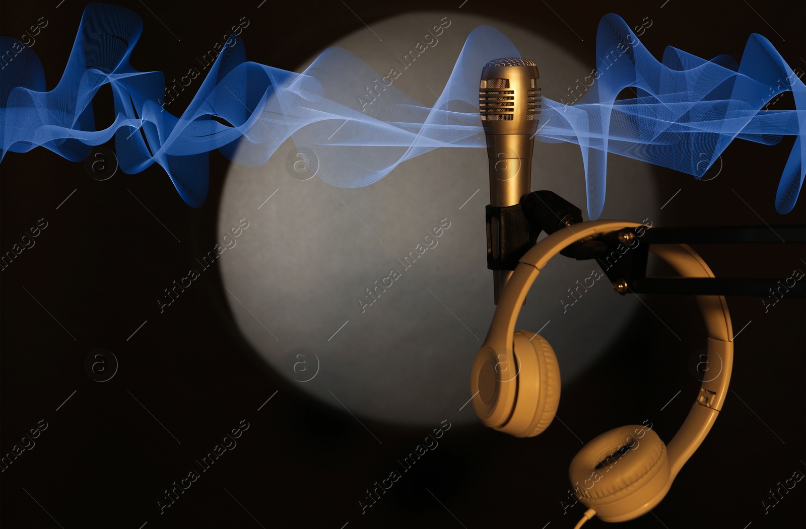 Image of Microphone, headphones and sound waves on stage