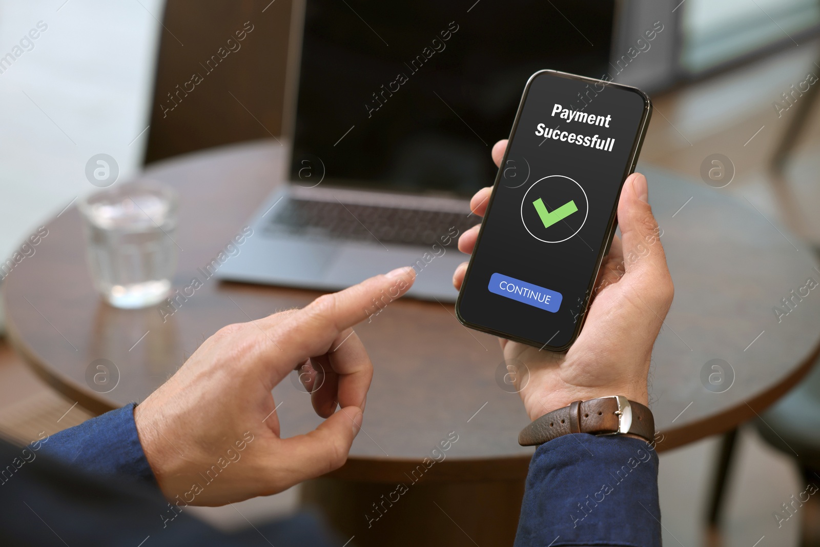 Image of Man using online payment application on mobile phone indoors, closeup