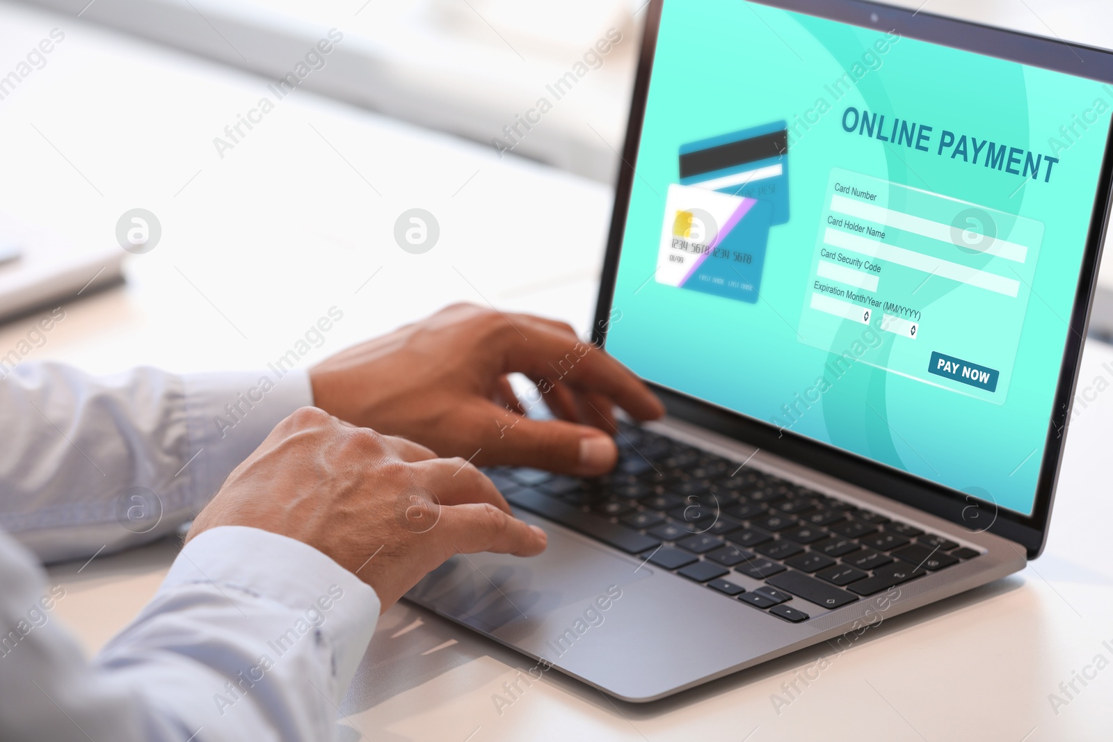 Image of Man using online payment application on laptop at table, closeup