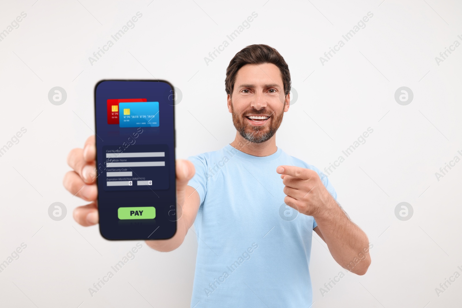 Image of Happy man pointing at mobile phone with online payment application screen on light grey background
