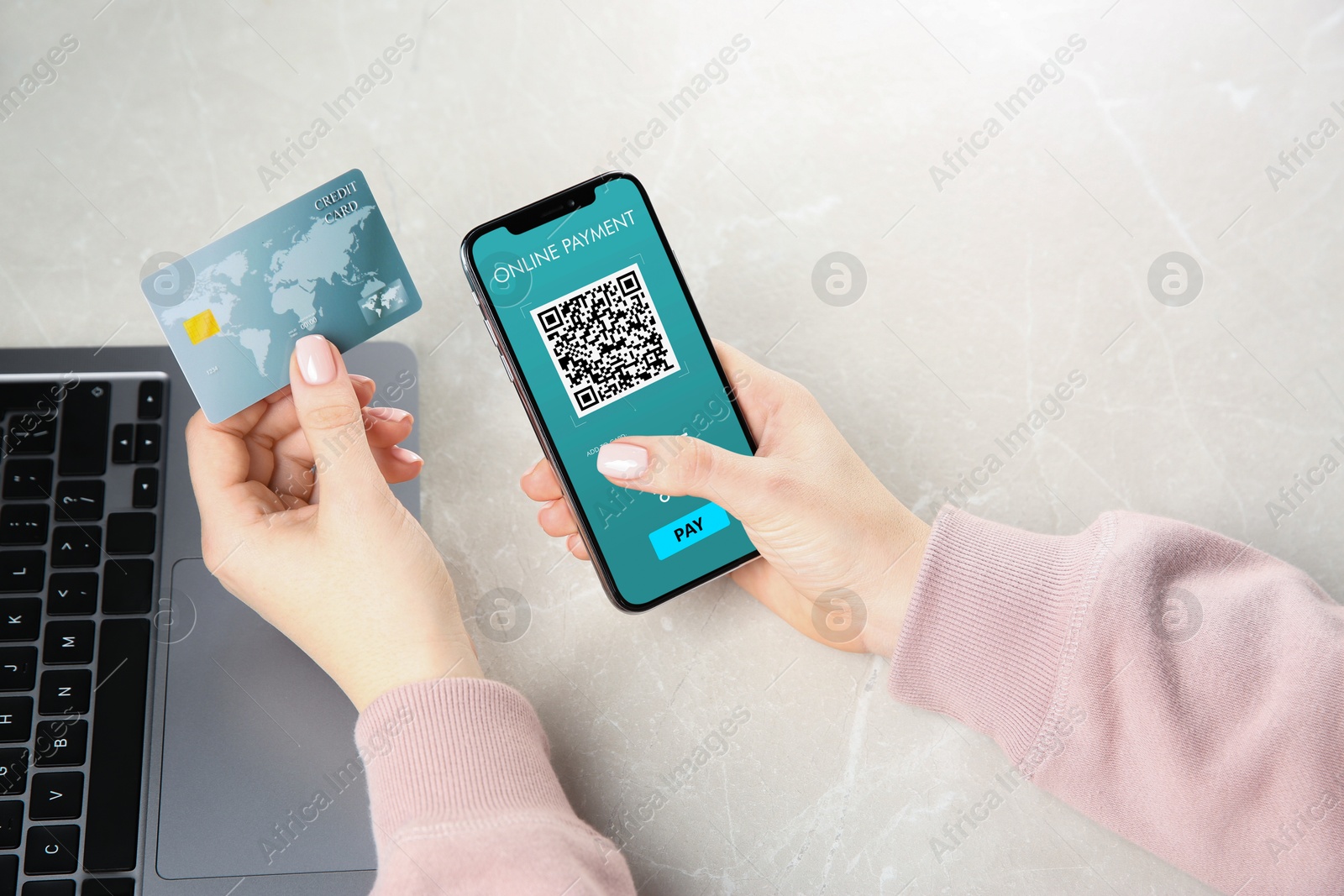 Image of Woman using online payment application on mobile phone at table, closeup