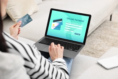 Image of Woman using online payment application on laptop at home, closeup