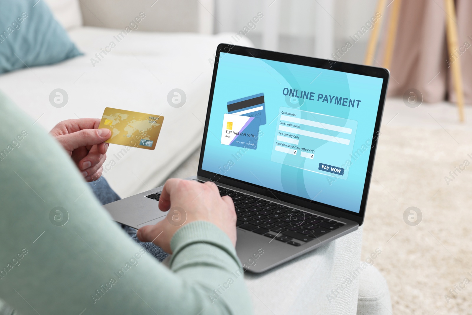 Image of Man using online payment application on laptop at home, closeup