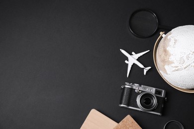 Photo of Travel blogger. Flat lay composition with vintage camera on black background, space for text