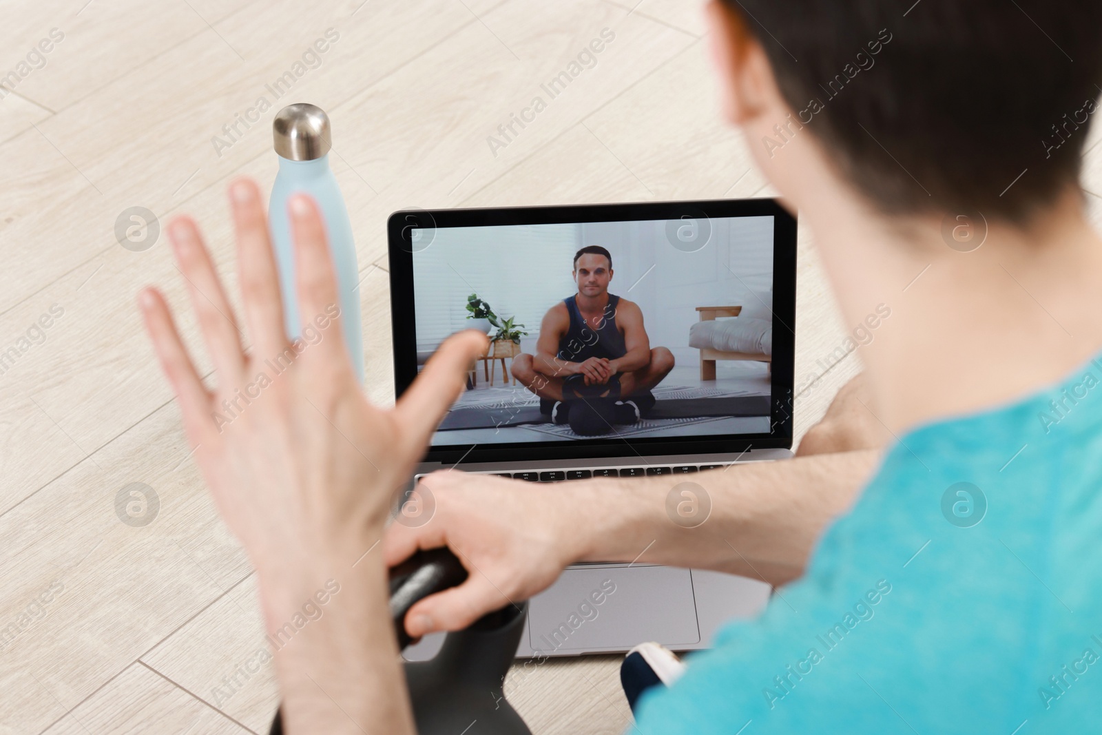 Photo of Online fitness trainer. Man having video chat via laptop indoors, closeup