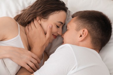 Lovely couple spending time together in bed
