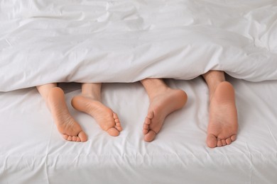 Photo of Lovely couple lying in bed, closeup view