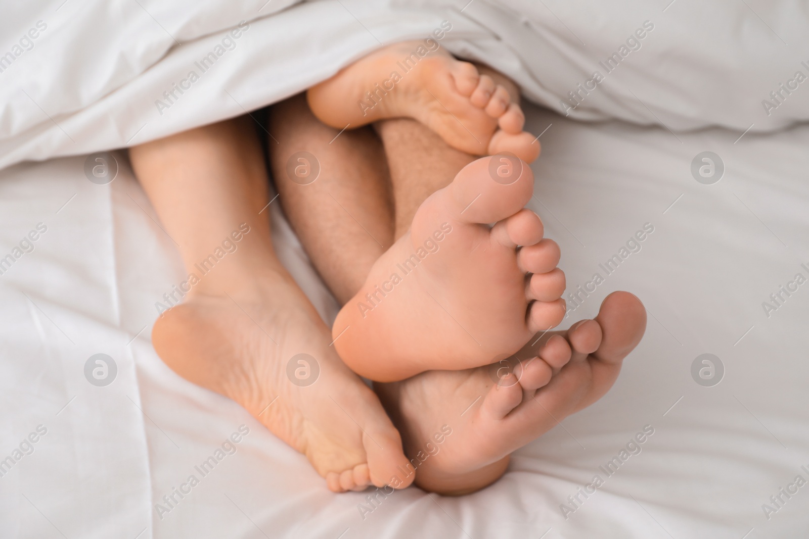 Photo of Lovely couple lying in bed, closeup view