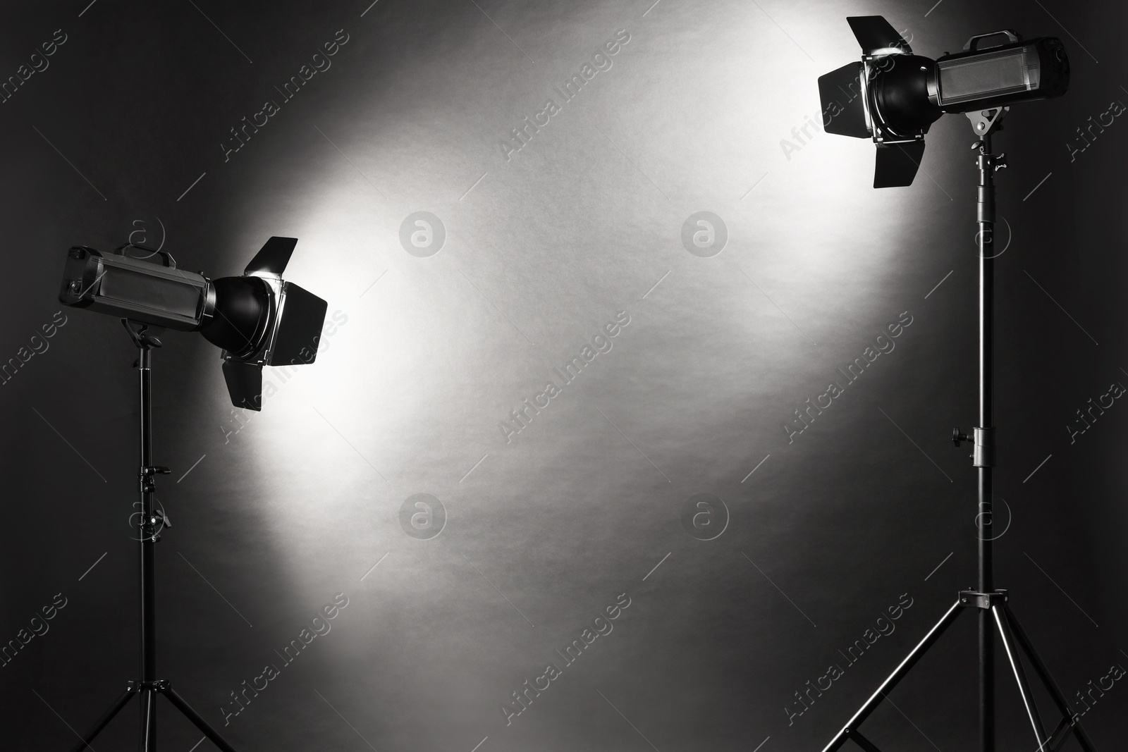 Photo of Dark photo background and professional lighting equipment in studio