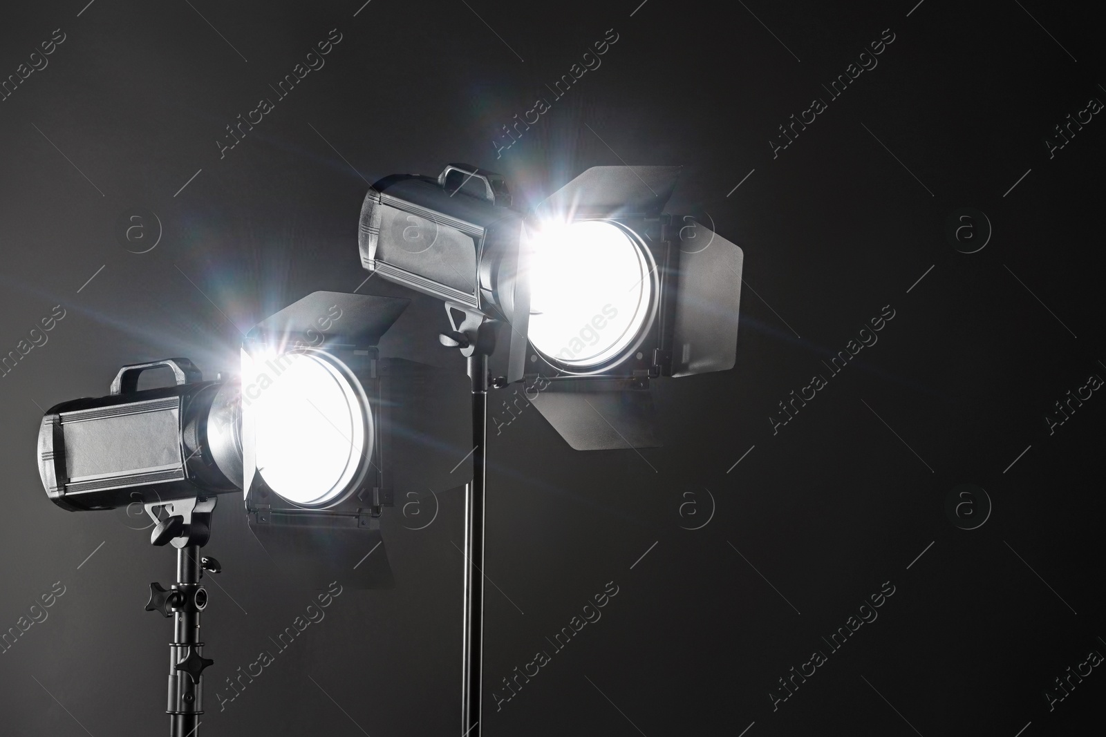 Photo of Dark photo background and professional lighting equipment in studio