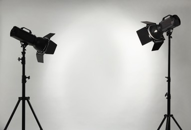 Grey photo background and professional lighting equipment in studio