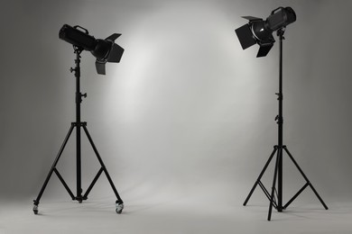 Photo of Grey photo background and professional lighting equipment in studio