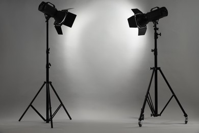 Grey photo background and professional lighting equipment in studio